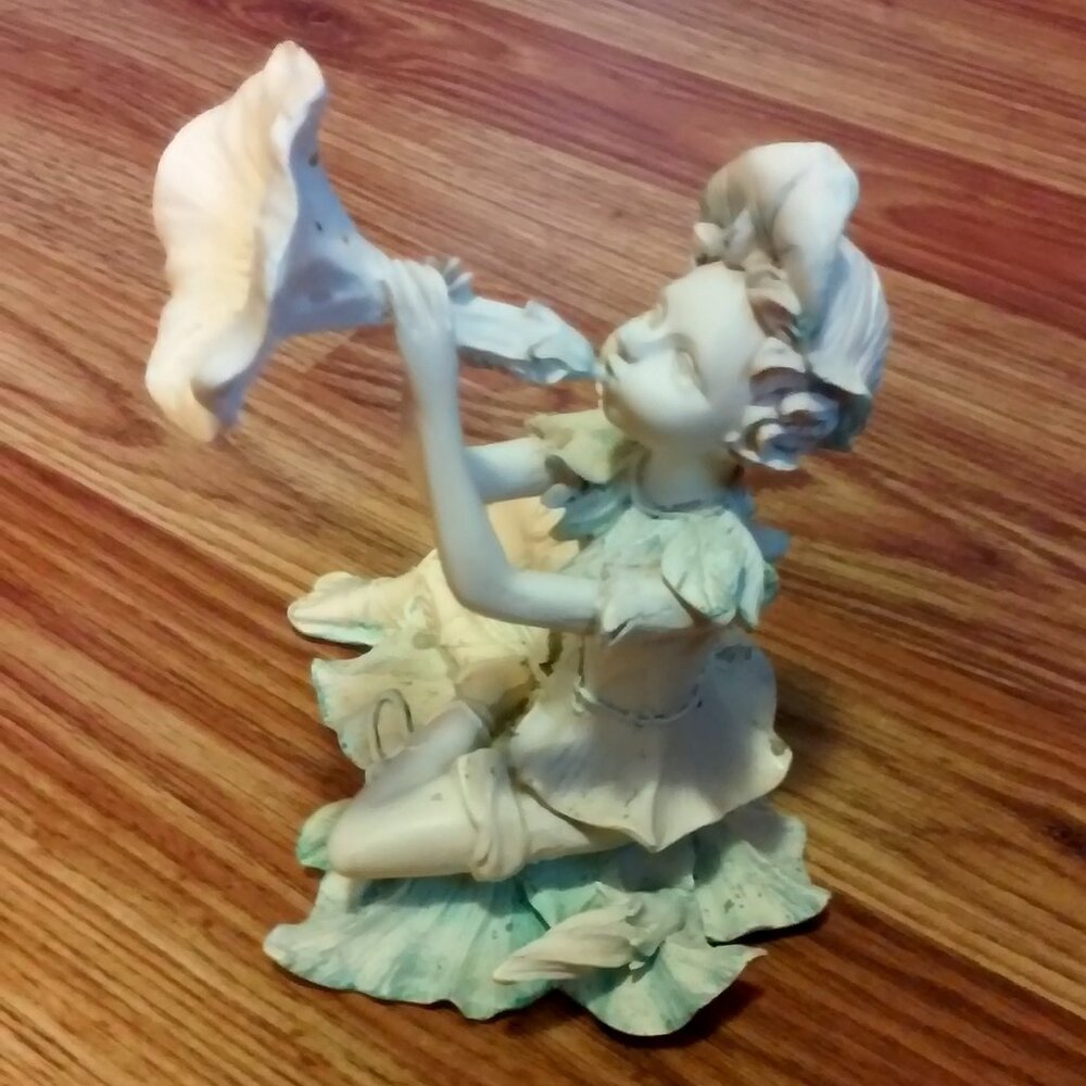 Ceramic Pixie Statue Blowing Flower Horn 7" Tall 5" Across 5" Thick